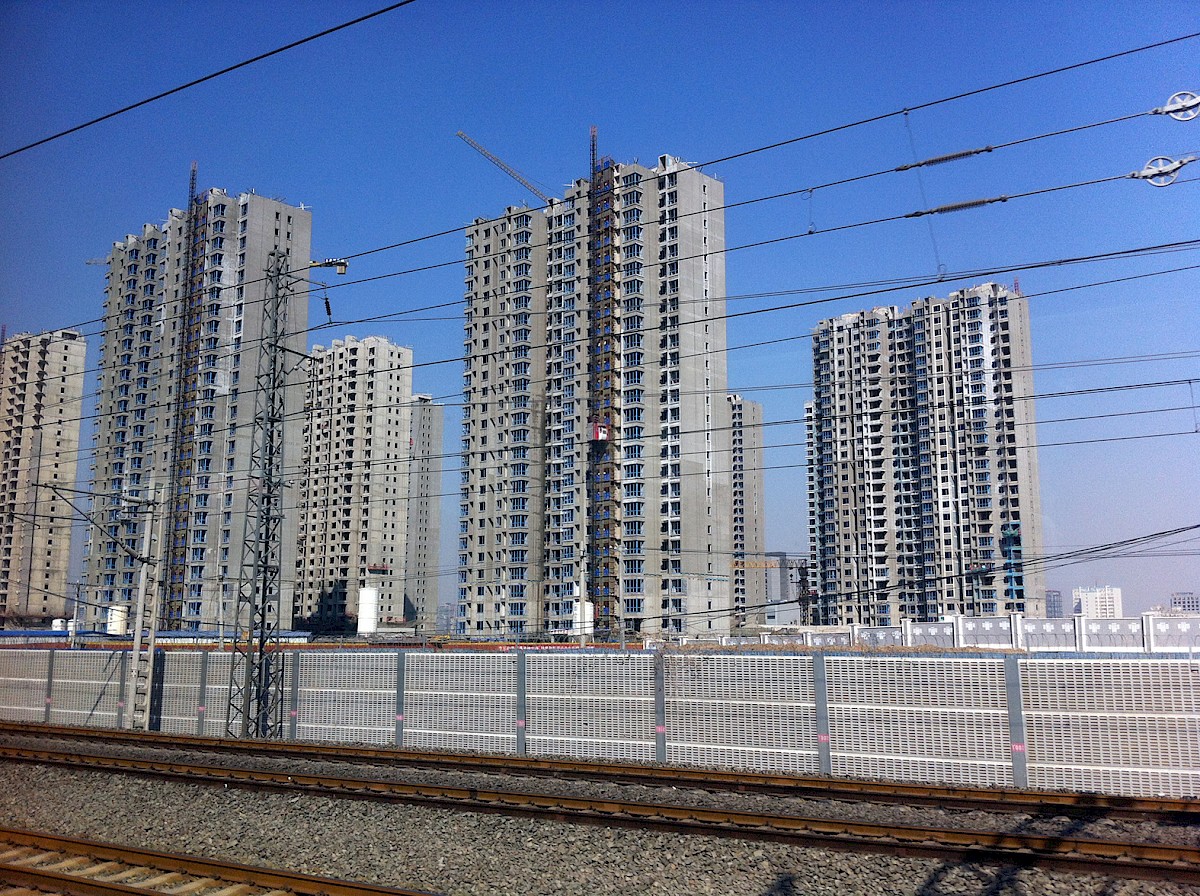 View from a train passing by a random empty city still being built